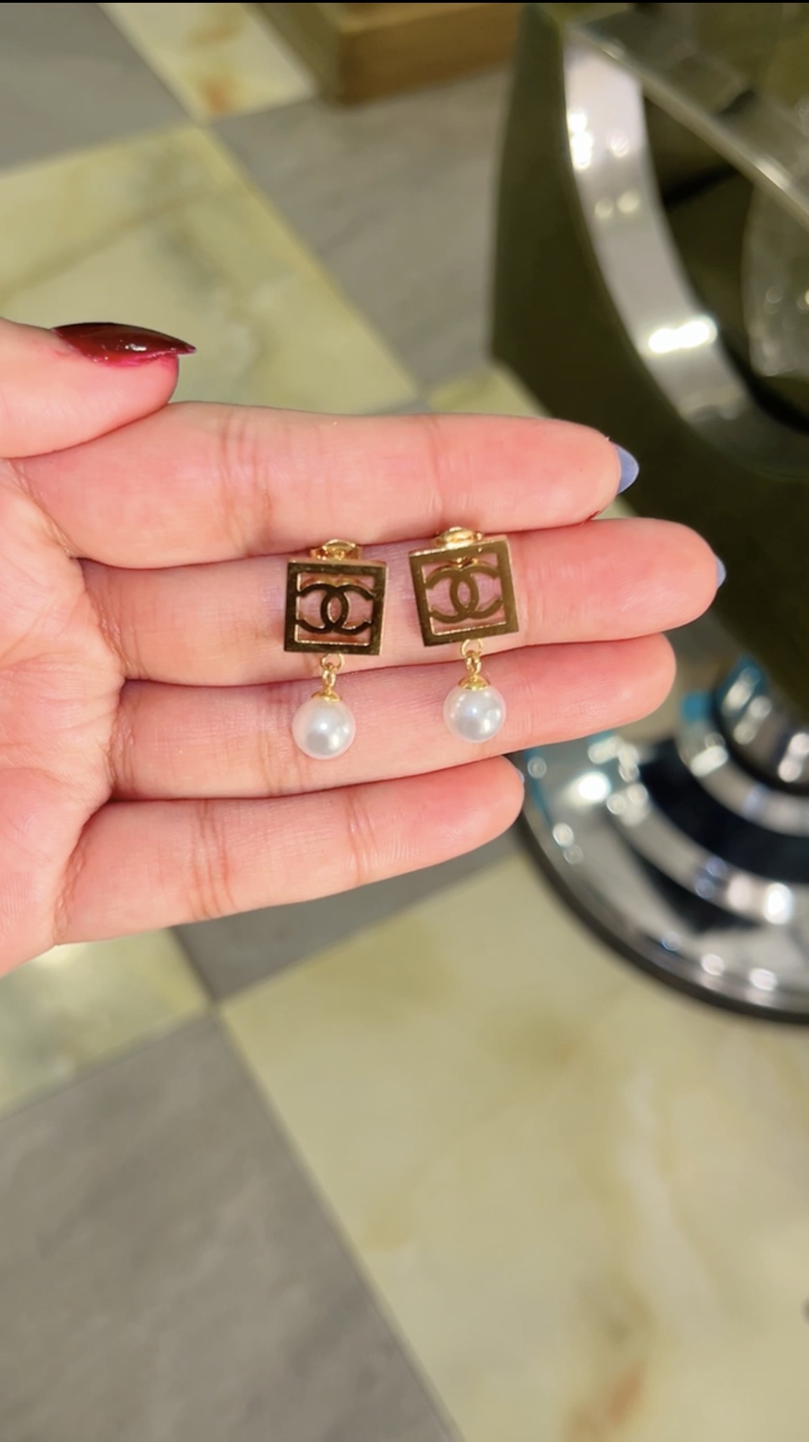 Framed emblem stud earrings finished with a single pearl