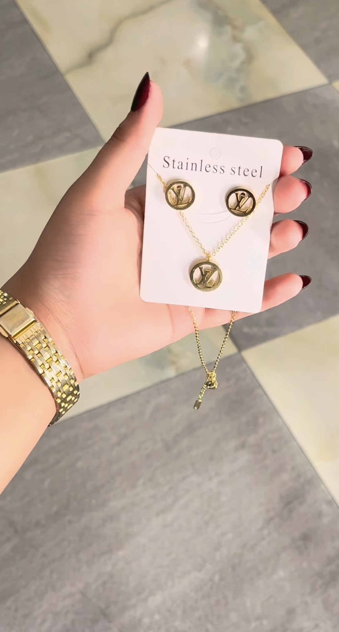 Gold monogram earrings and necklace set on card